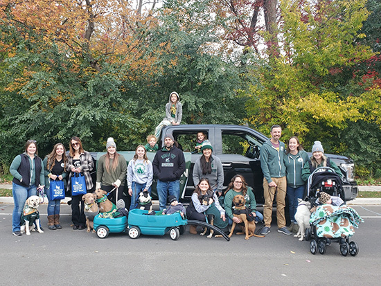 Evergreen Veterinary Clinic staff posing at football tailgate event in front of pickup truck